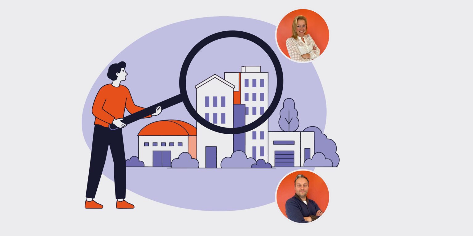 Person in orange shirt uses a large magnifying glass to inspect a city of buildings, symbolizing real estate search.